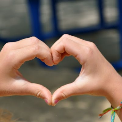 Child hands making a heart