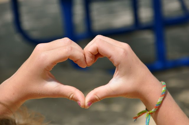 Child hands making a heart 