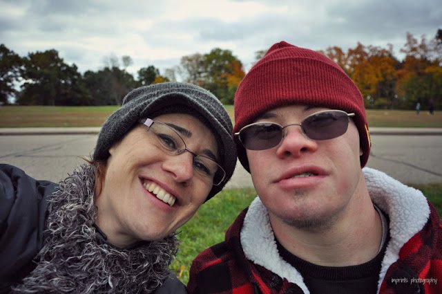 Sibling with her brother with Down Syndrome with hats on 