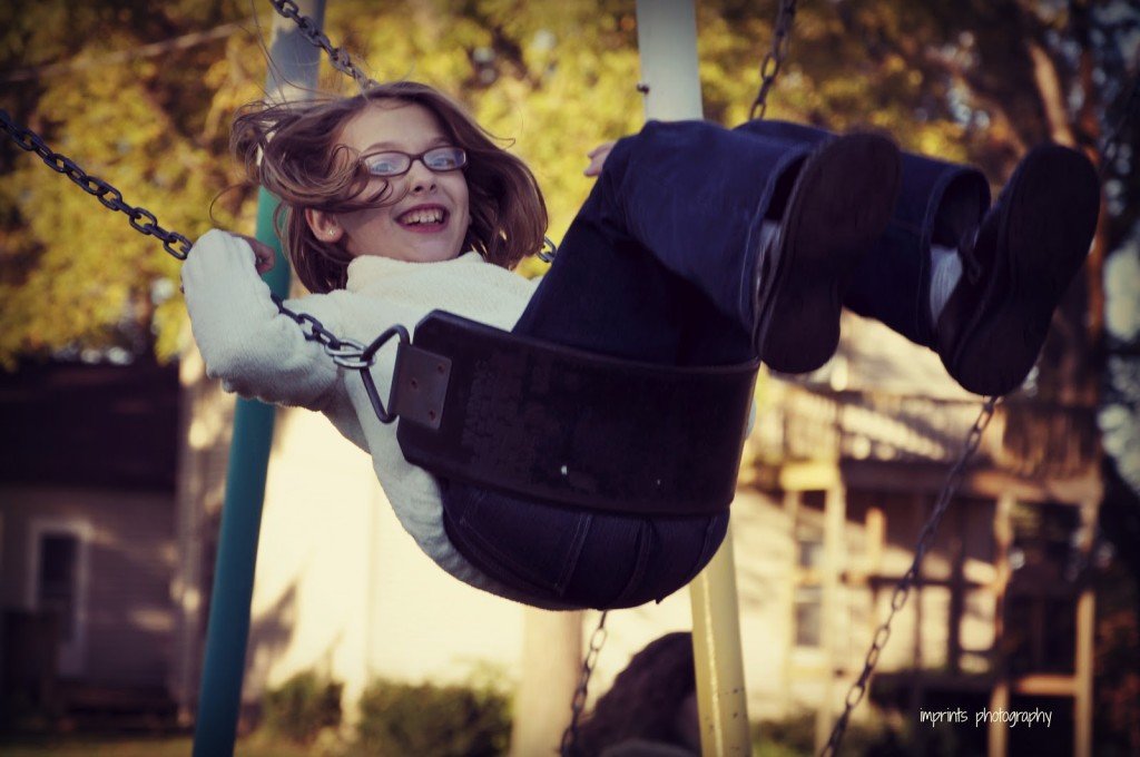 Girl on swing in fall by Katie M. Reid Photogprahy