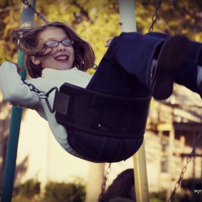 Girl on swing in fall by Katie M. Reid Photogprahy