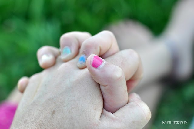 chipped nailed polished fingers holding hands 