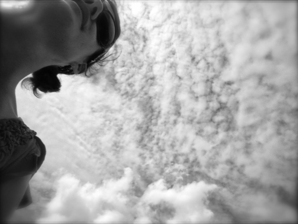 Girl against clouds in black and white 