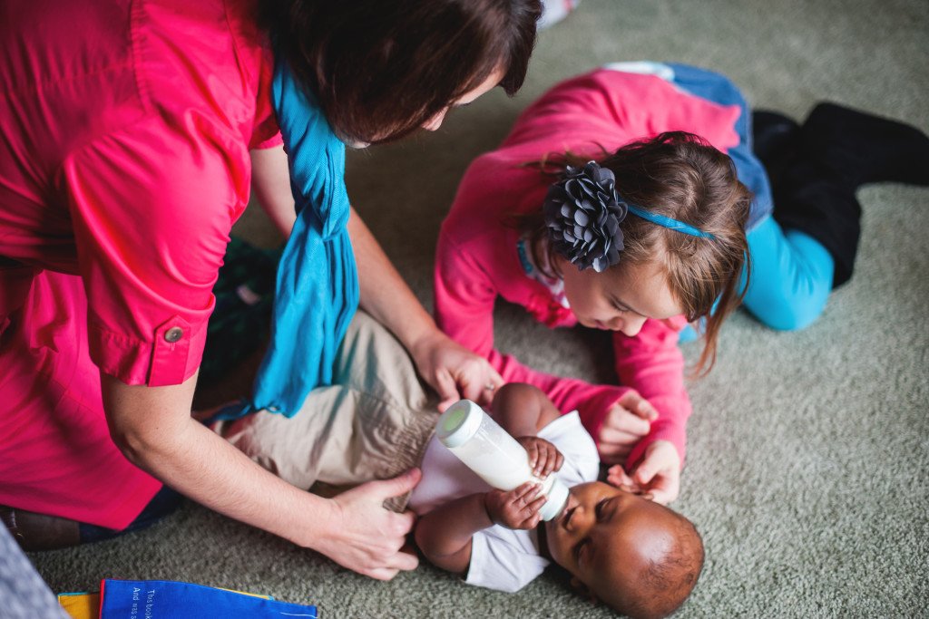 Mother, daughter, caring for baby by Alyssa and Drew Photography 