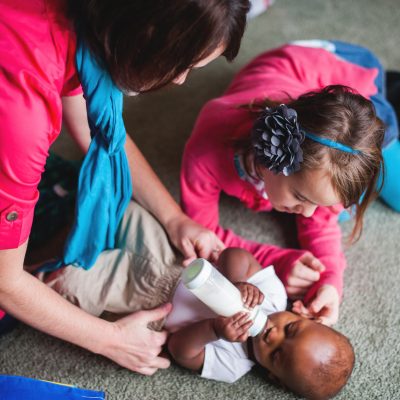 Mother, daughter, caring for baby by Alyssa and Drew Photography