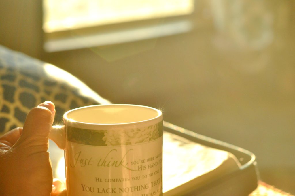 Holding tea mug at sunrise by Katie M Reid Photography